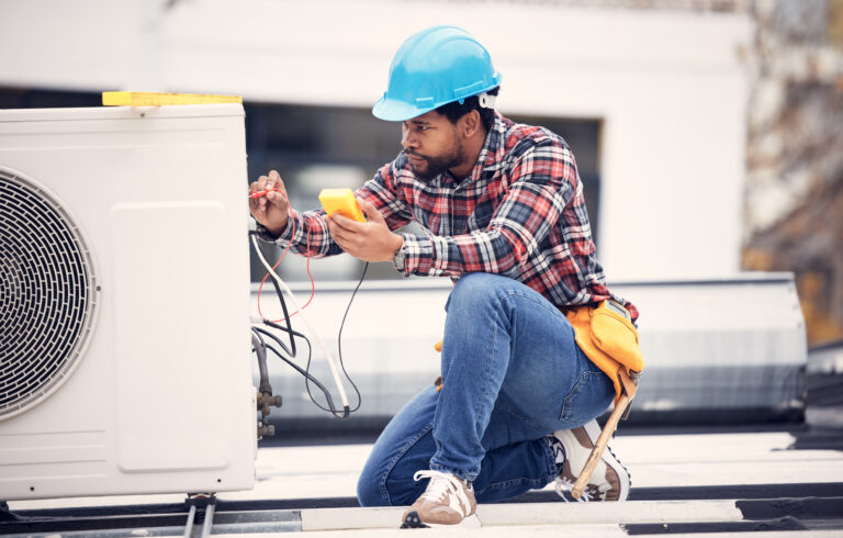 A professional technician checking a heat pump for maintenance